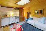 Discover this charming property featuring a cozy interior with wooden paneling and a skylight that fills the space with natural light.