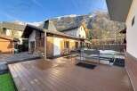 This stunning property boasts a spacious wooden deck, perfect for outdoor entertaining and relaxation.