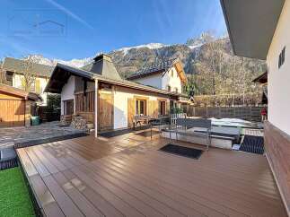 This stunning property boasts a spacious wooden deck, perfect for outdoor entertaining and relaxation.