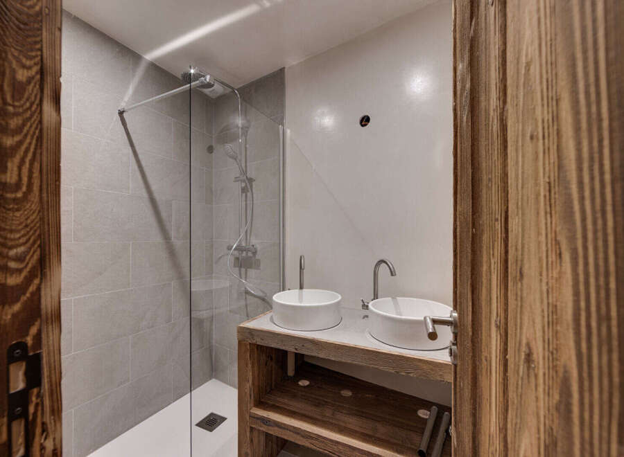 This modern bathroom features a sleek shower with glass doors and a minimalist design.