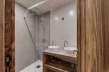 This modern bathroom features a sleek shower with glass doors and a minimalist design.