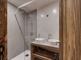This modern bathroom features a sleek shower with glass doors and a minimalist design.