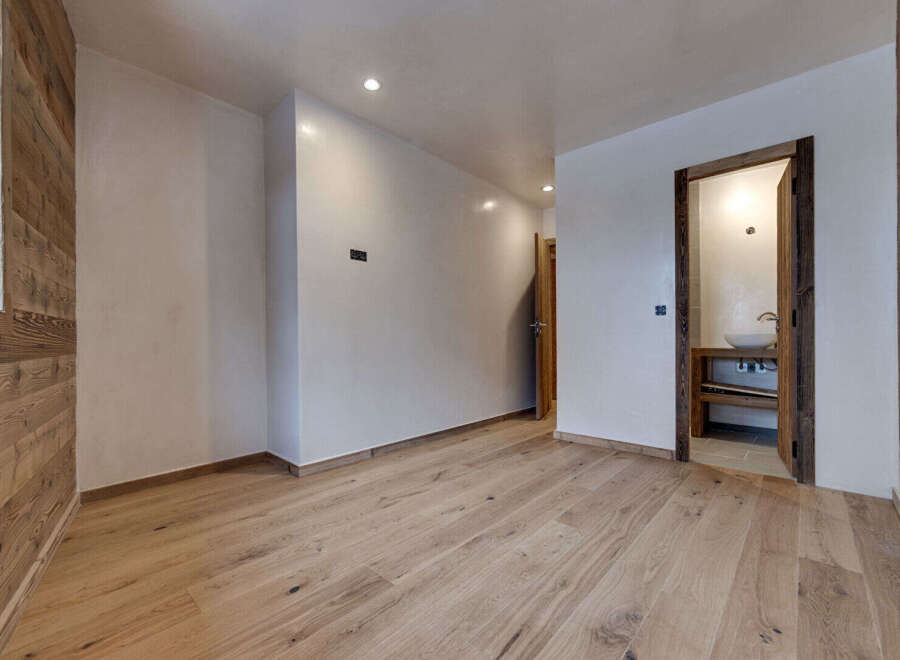 This stunning property boasts a modern interior with beautiful wooden floors and walls, creating a warm and inviting atmosphere.