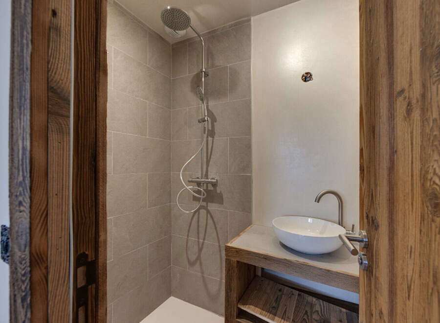 Step into luxury with this stunning bathroom featuring a modern shower and a stylish sink.