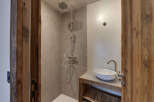 Step into luxury with this stunning bathroom featuring a modern shower and a stylish sink.