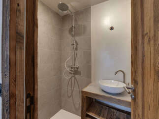 Step into luxury with this stunning bathroom featuring a modern shower and a stylish sink.