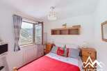 Discover a cozy bedroom with stunning mountain views.