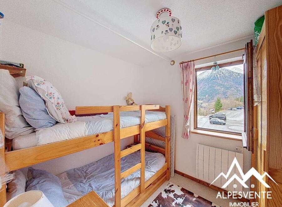 This charming bedroom features a cozy bunk bed, perfect for accommodating guests or family members.