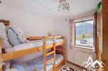 This charming bedroom features a cozy bunk bed, perfect for accommodating guests or family members.