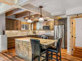 This stunning kitchen boasts a rustic yet modern design, perfect for entertaining and everyday living.