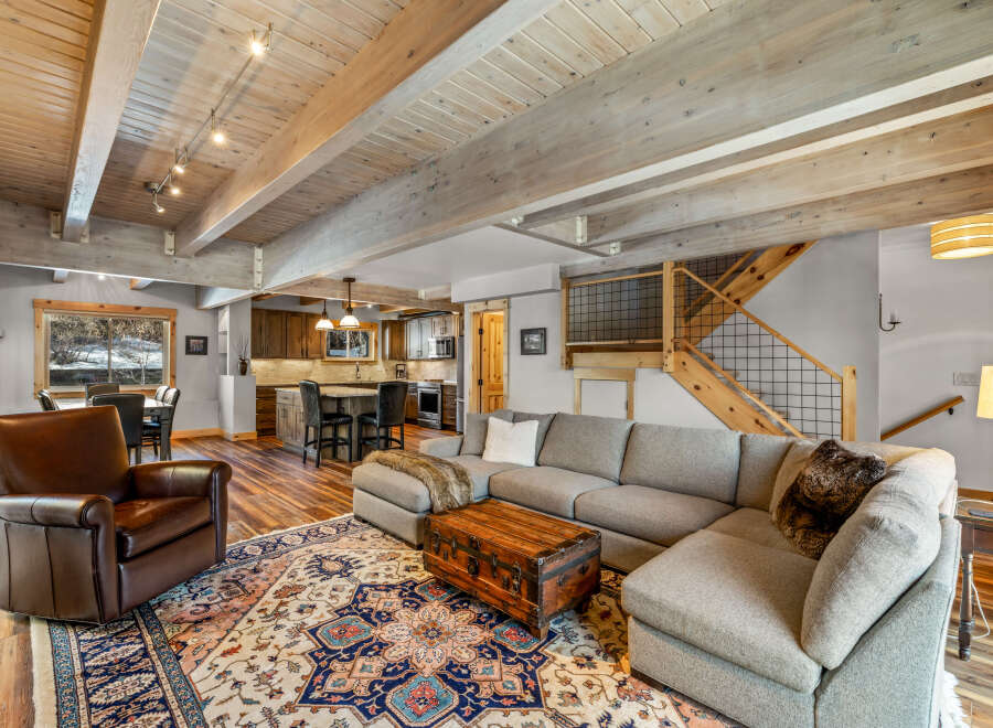 This stunning living space boasts a cozy sectional sofa, perfect for relaxing and entertaining.