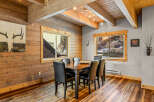 This stunning dining room features a rustic design with wood paneling and a beautiful wooden table.