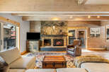 Step into luxury with this stunning living space, featuring a cozy fireplace and a rustic, inviting ambiance.