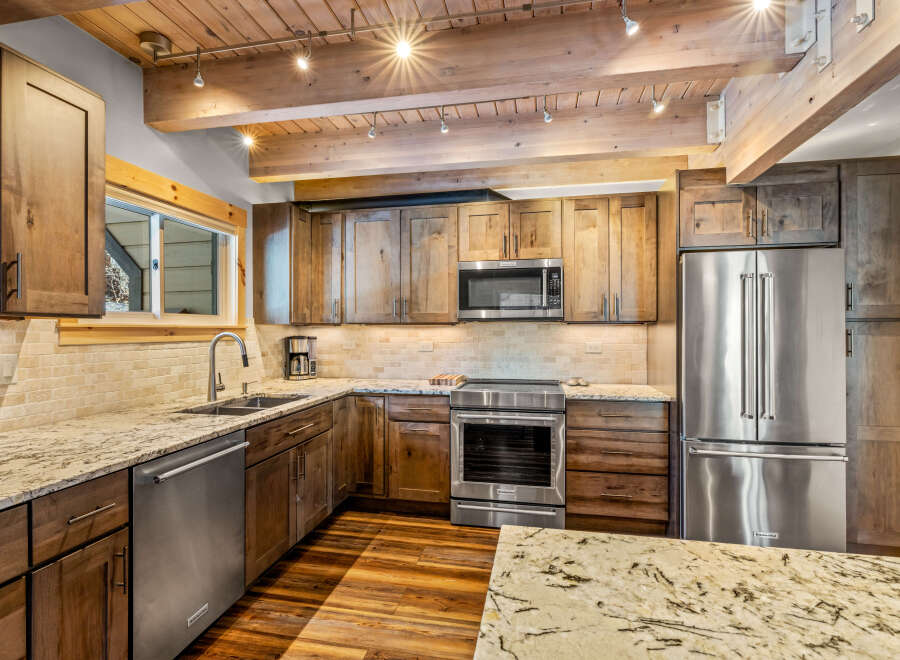 This stunning kitchen boasts custom cabinetry, stainless steel appliances, and elegant granite countertops.