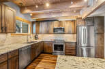 This stunning kitchen boasts custom cabinetry, stainless steel appliances, and elegant granite countertops.