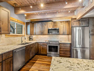 This stunning kitchen boasts custom cabinetry, stainless steel appliances, and elegant granite countertops.