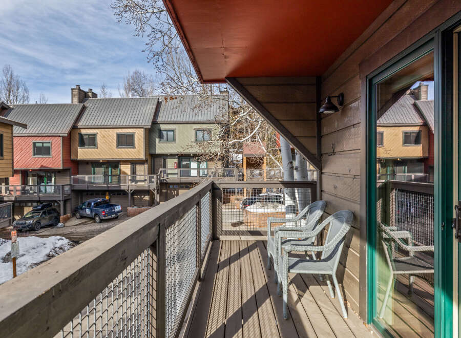 Enjoy stunning views from this charming balcony overlooking a beautiful mountain town.