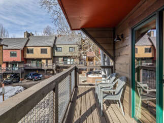 Enjoy stunning views from this charming balcony overlooking a beautiful mountain town.