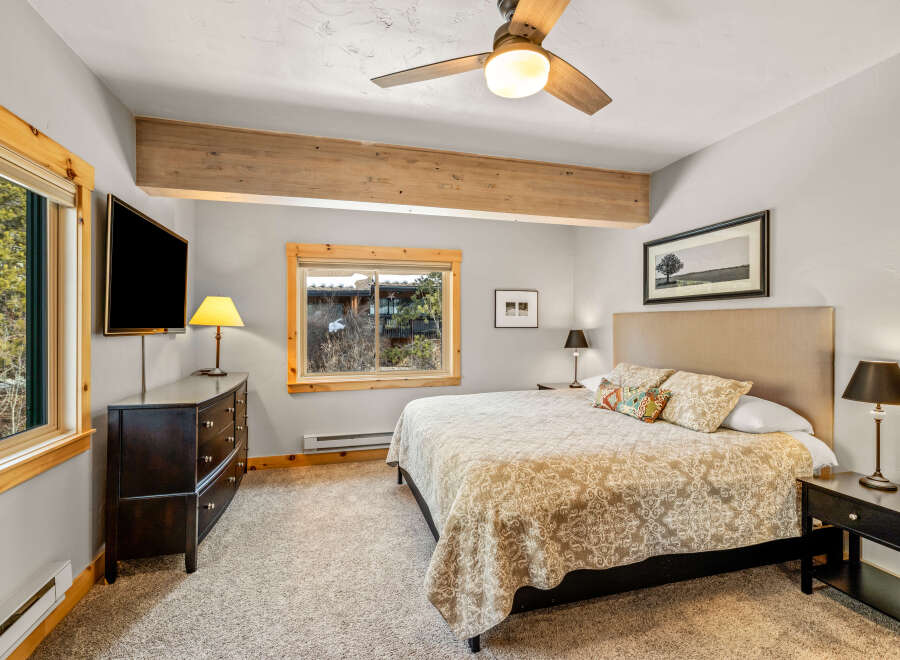 This cozy bedroom features a comfortable bed with patterned bedding, perfect for a relaxing retreat.