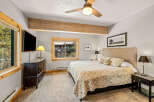 This cozy bedroom features a comfortable bed with patterned bedding, perfect for a relaxing retreat.
