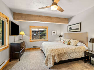 This cozy bedroom features a comfortable bed with patterned bedding, perfect for a relaxing retreat.