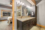 This stunning bathroom boasts a modern design with a double vanity and granite countertops, offering ample space and luxury.
