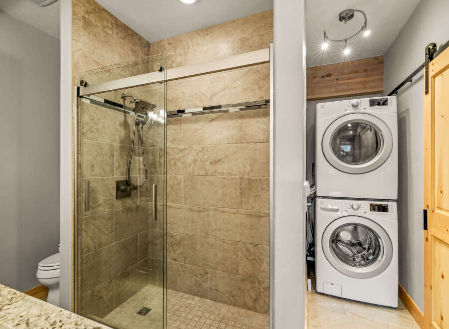 This stunning bathroom features a modern glass shower with a sleek design.