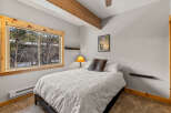 This cozy bedroom features a comfortable bed with a decorative comforter and pillows.