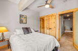 This cozy bedroom features a comfortable bed with a stylish white comforter and a decorative pillow.