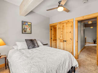 This cozy bedroom features a comfortable bed with a stylish white comforter and a decorative pillow.