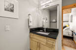 This stunning bathroom boasts a sleek black countertop and a modern sink, perfect for a stylish and functional space.