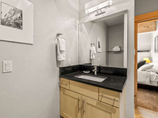 This stunning bathroom boasts a sleek black countertop and a modern sink, perfect for a stylish and functional space.