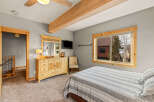 This cozy bedroom features a comfortable bed with striped bedding, perfect for a relaxing retreat.