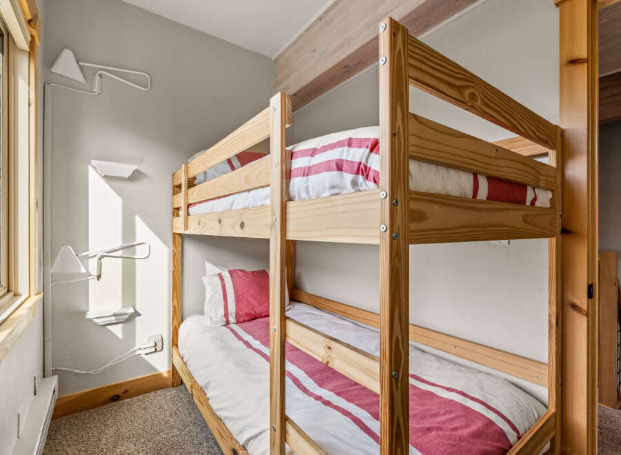 This cozy bedroom features a charming bunk bed, perfect for accommodating guests or family members.