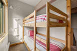 This cozy bedroom features a charming bunk bed, perfect for accommodating guests or family members.