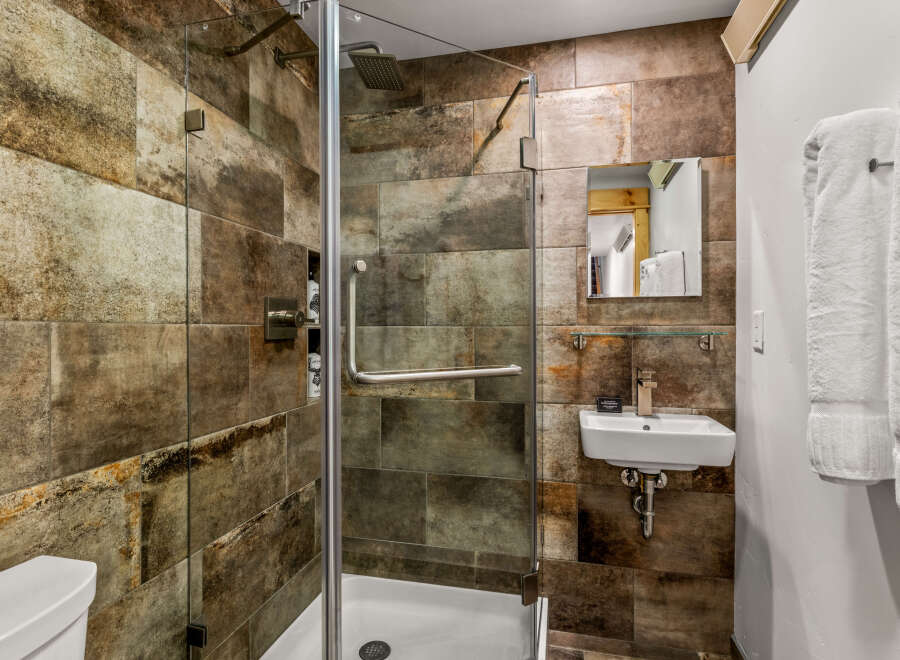 Step into a luxurious bathroom featuring a stunning walk-in shower with a glass door.
