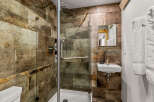 Step into a luxurious bathroom featuring a stunning walk-in shower with a glass door.