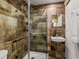 Step into a luxurious bathroom featuring a stunning walk-in shower with a glass door.