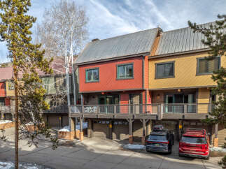 Discover the charm of this stunning property featuring a vibrant red and yellow exterior, complemented by a modern metal roof.