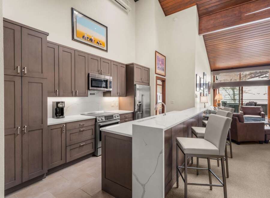 This stunning kitchen boasts modern cabinetry, sleek countertops, and high-end appliances, perfect for culinary enthusiasts.