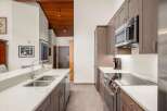 Step into this stunning kitchen, featuring sleek cabinetry and modern appliances.