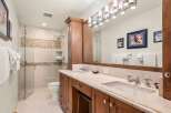 Step into luxury with this stunning bathroom featuring a spacious vanity with dual sinks and ample storage.