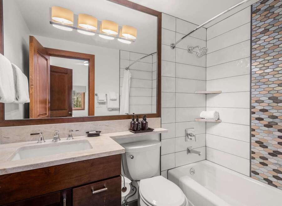 Step into a luxurious bathroom featuring a sleek design and modern amenities.