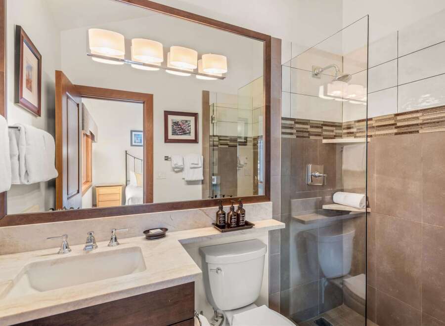 Step into a luxurious bathroom featuring a sleek glass shower and modern fixtures.