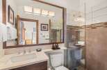 Step into a luxurious bathroom featuring a sleek glass shower and modern fixtures.