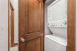 This stunning property boasts a convenient laundry area, featuring a modern stacked washer and dryer.