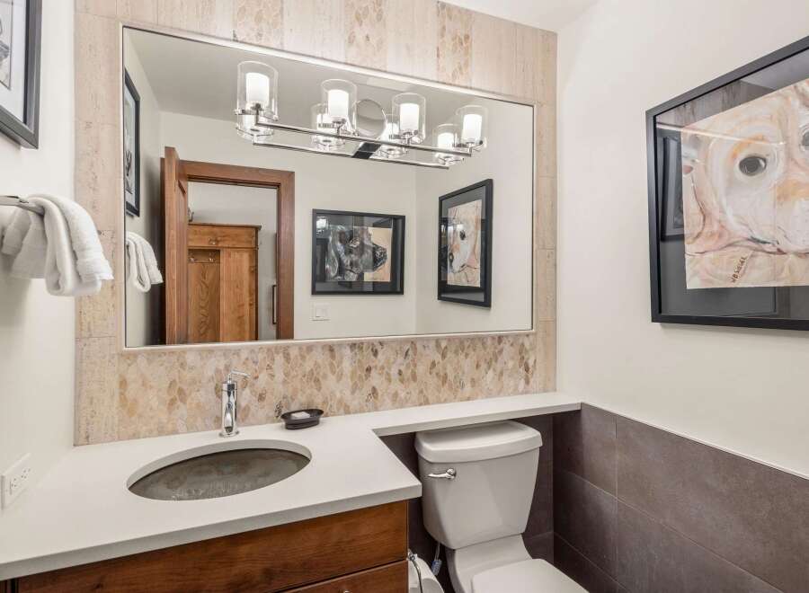 This stunning bathroom features a modern design with a beautiful vanity and a sleek sink.