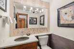This stunning bathroom features a modern design with a beautiful vanity and a sleek sink.