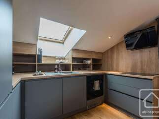 Discover modern living in this stylish kitchen, featuring sleek gray cabinetry and warm wooden accents.