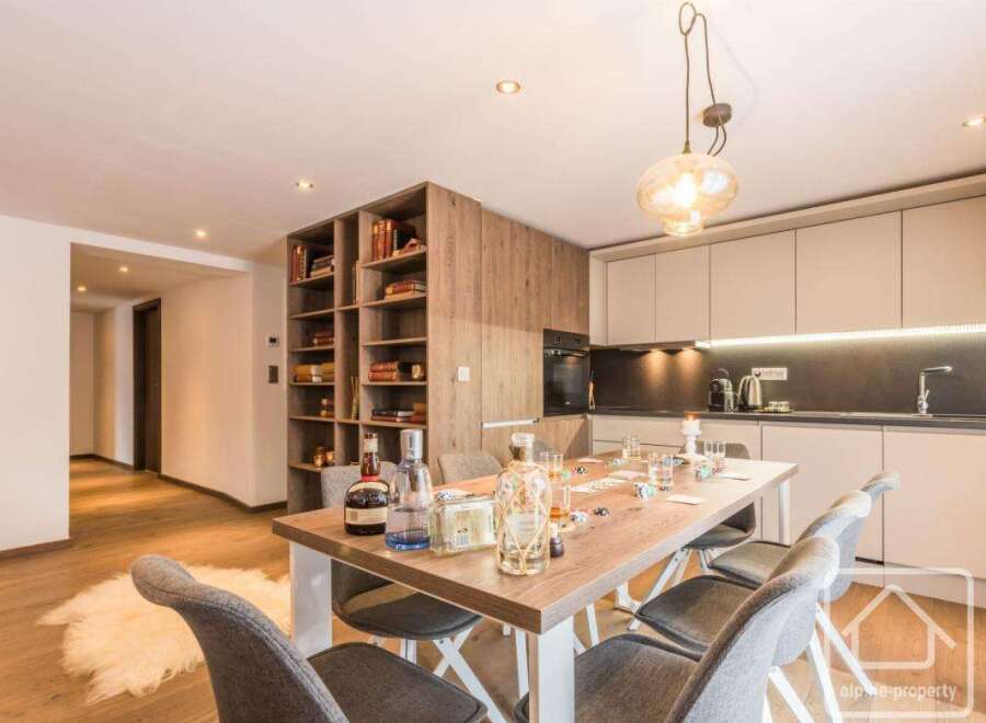 This stunning property boasts a modern kitchen with sleek cabinetry and a cozy dining area, perfect for entertaining.